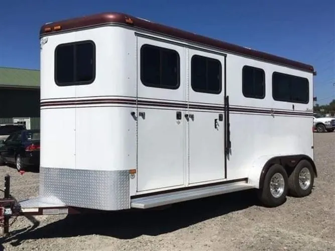 2007 Hawk 2 horse bumper pull in white with burgundy trim and side ramp doors, angled side view