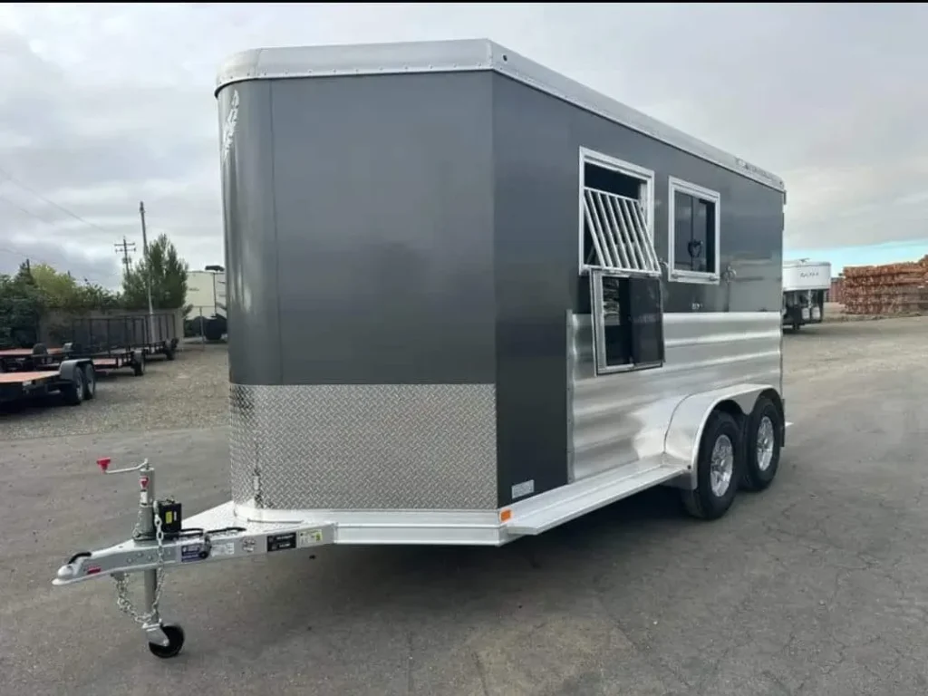 2012 Featherlite 9400 2 horse bumper pull in charcoal grey, front three-quarter view on a paved lot