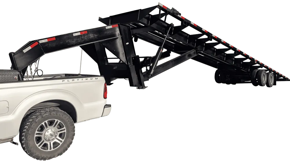40 ft gooseneck tilt bed container chassis hitched to a white pickup with the bed tilted, side view on white